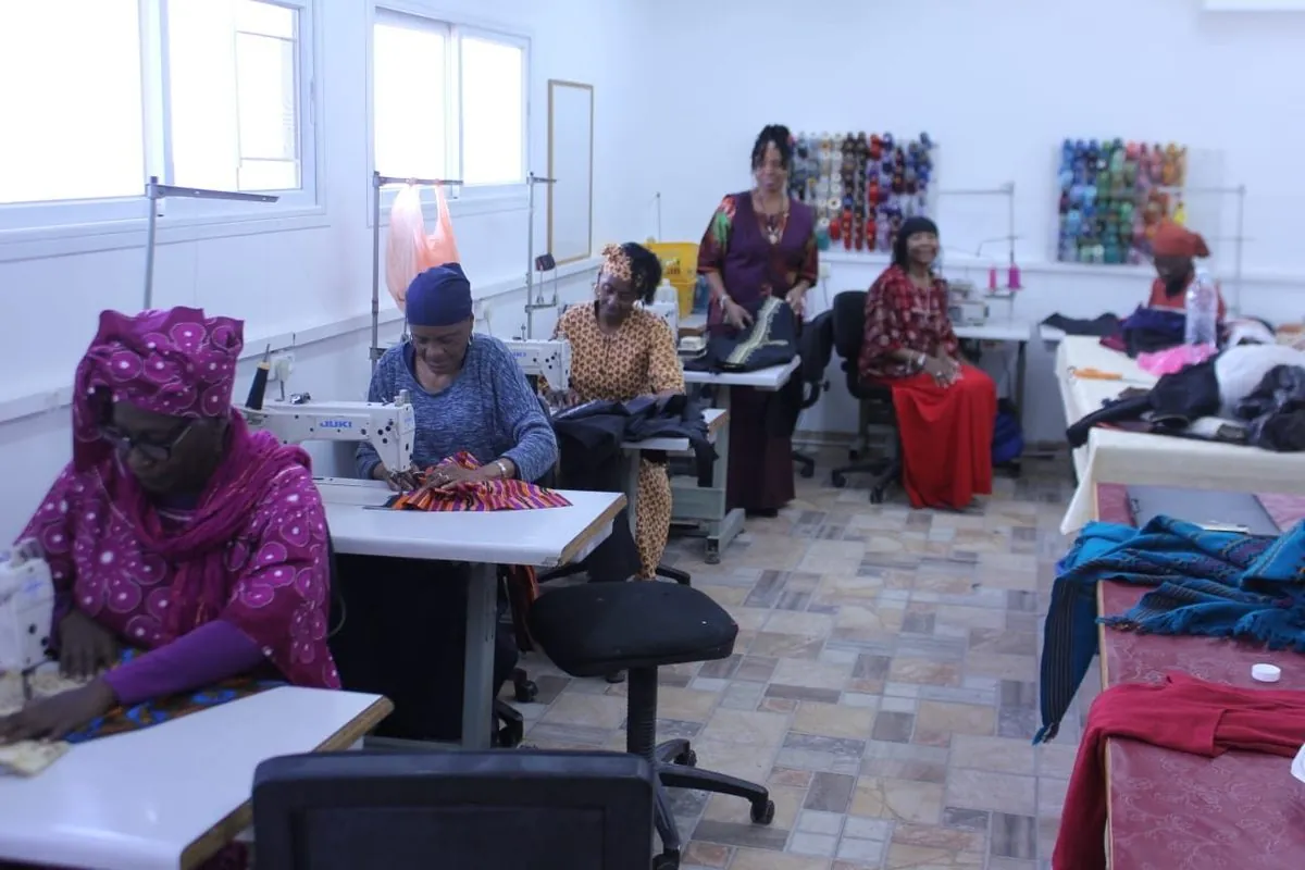 Seamstresses at their machines in the workroom of the Communal Sewing Centre